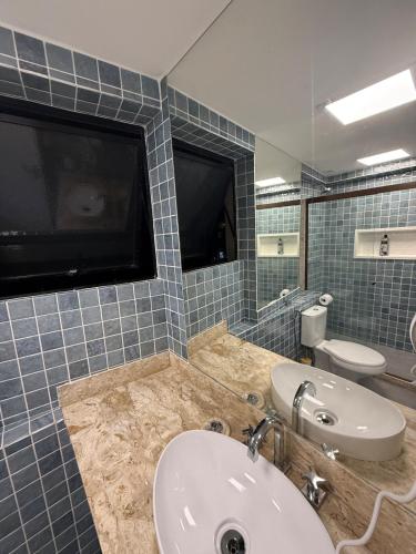 a bathroom with a sink and a mirror at Apartamento em Copacabana in Rio de Janeiro