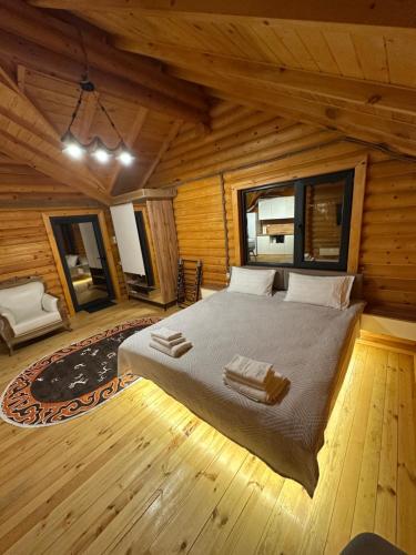 a bedroom with a bed in a log cabin at Лесник in Cholpon-Ata