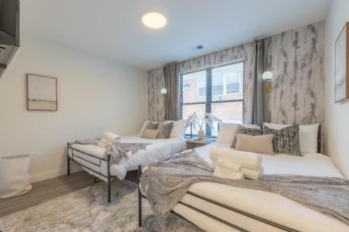 a bedroom with two beds and a window at Opulence in Olive with Free Parking, 2 BR 2 baths Suite, 5 beds and Sleeps 8 in Orange