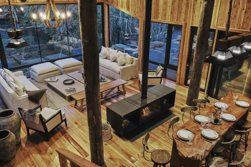 an overhead view of a living room with a fireplace at Lodge El Remanso, Patagonia Chile in Llanada Grande