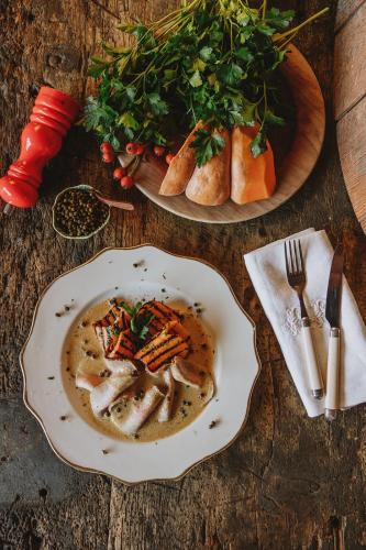 a table with a plate of soup and a plate of food at Relais Sant'Elena in Bibbona