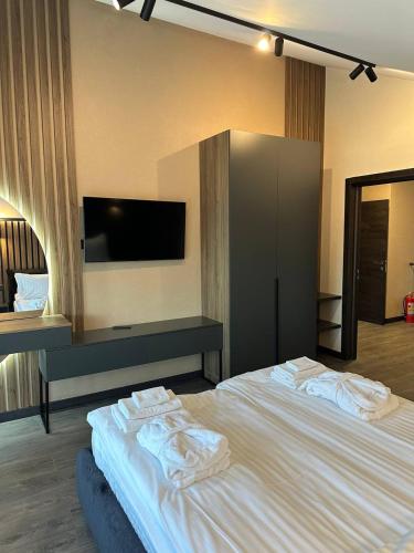 a bedroom with a large bed with towels on it at Chalet 348 in Palyanytsya