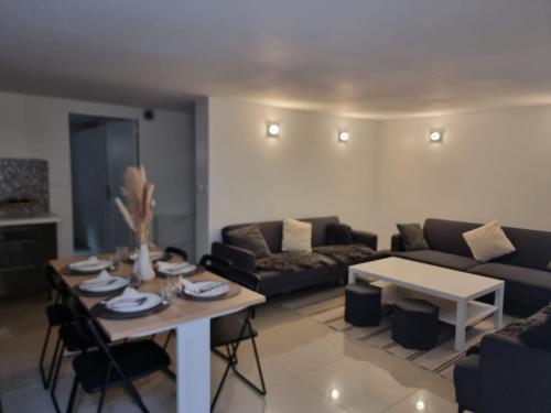 a living room with a couch and a table at Séjour à Paris in Bezons