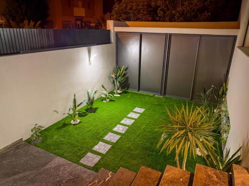 an image of a garden with grass and plants at Villa signature - Piscine prive - Spacieuse à Founty in Agadir