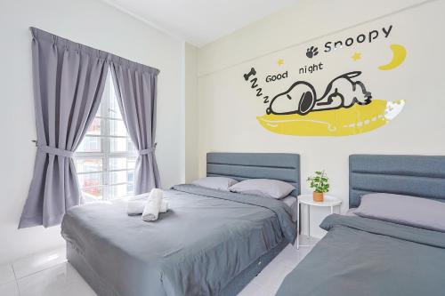 a bedroom with two beds and a sign that reads good night at Perfect for Families & Friends, Retreat Clover Home 2-20 in Brinchang