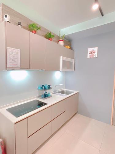 a kitchen with white cabinets and a sink at Happiness blossoms Homestay in Wujie