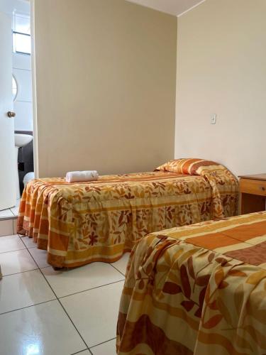 Postel nebo postele na pokoji v ubytování HOSPEDAJE LAS FLORES ICA