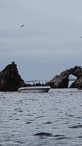 a boat with people on it in the water at Hotel Riviera Inka Paracas in Paracas