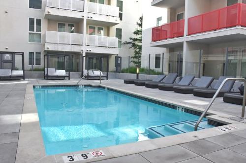 a swimming pool in front of a building at Stylish LA studio Prime Location in Los Angeles