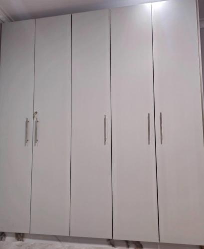 a group of white cabinets in a room at Zanzi Layover JKIA and SGR in Jomo Kenyatta Airport Nairobi