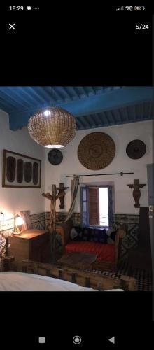 a living room with a couch and a table at Artistic house in the middle of Essaouira in Essaouira