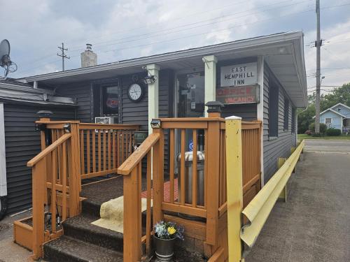 a small building with a porch and a store at Hotel O East Hemphill Burton-Flint in Burton