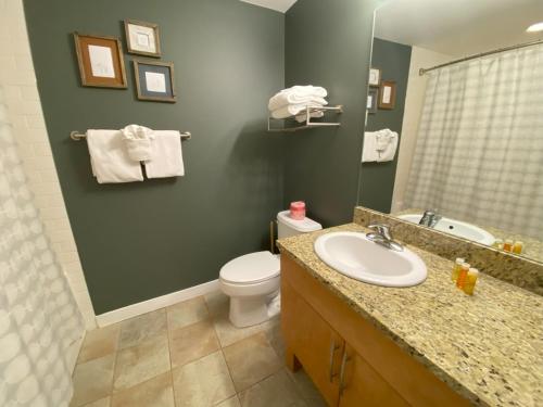 a bathroom with a sink and a toilet and a mirror at Fraser Crossing Top floor 3603 in Winter Park