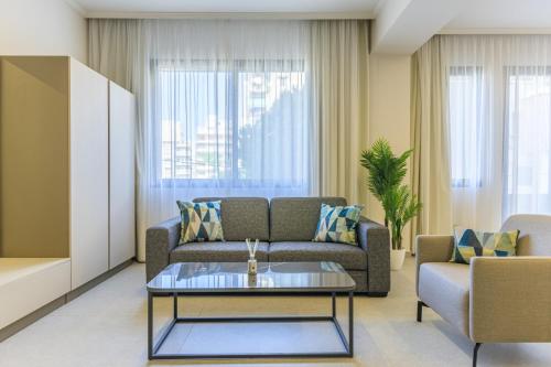 a living room with a couch and a table at CityZen - Boutique Studios in Achrafieh in Beirut