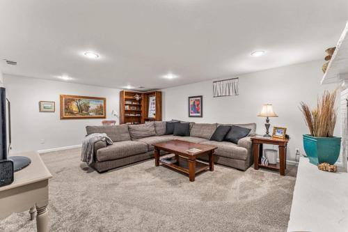 a living room with a couch and a table at Modern Downtown Oasis Sunny Garden King Beds in Longmont