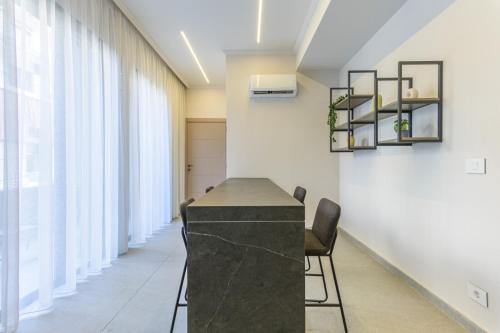 a conference room with a black counter and chairs at CityZen - Boutique Studios in Achrafieh in Beirut
