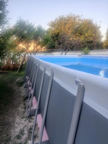 a row of chairs next to a swimming pool at Green Garden da Virna 2 in Torre Annunziata