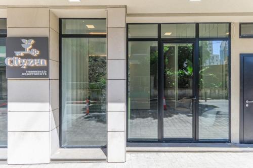 an entrance to a building with revolving glass doors at CityZen - Boutique Studios in Achrafieh in Beirut