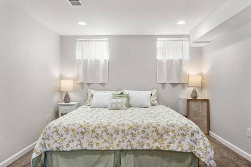 a bedroom with a large bed with two lamps at Modern Downtown Oasis Sunny Garden King Beds in Longmont