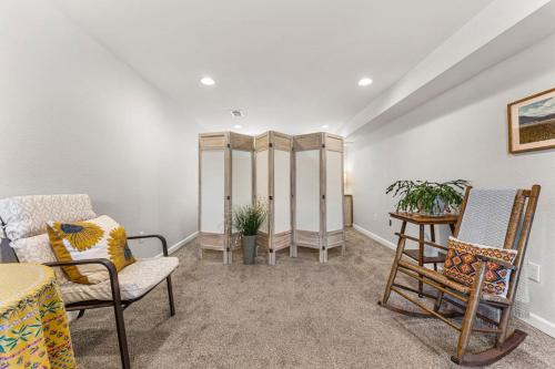 a living room with chairs and a table at Modern Downtown Oasis Sunny Garden King Beds in Longmont