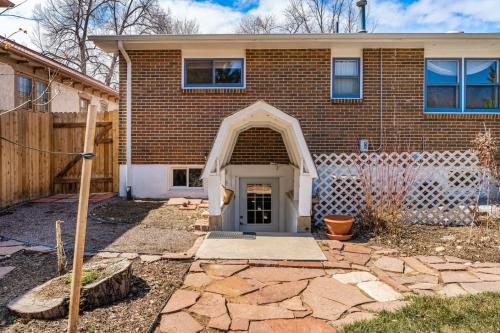 a brick house with an archway in front of it at Modern Downtown Oasis Sunny Garden King Beds in Longmont