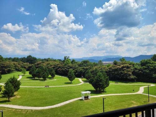 a view of a park with a gazebo and trees at Smoky View Haven- Indoor Pool, Playground, Walking Trail, Hot Tub in Pigeon Forge