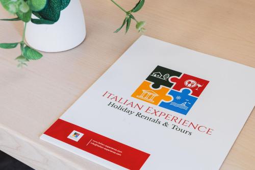 a book sitting on top of a table with a vase at Italian Experience- Suite Marè in Porto Recanati