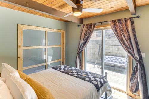 a bedroom with a bed and a large window at The Storybook Cottage Every Stay Tells a Story! in Conejo Valley Trailer Park
