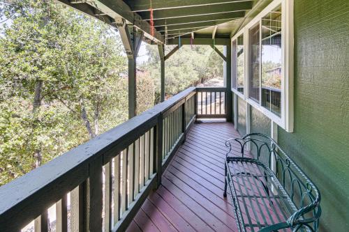 a bench sitting on the porch of a house at The Storybook Cottage Every Stay Tells a Story! in Conejo Valley Trailer Park