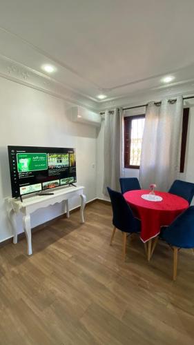 a living room with a red table and a tv at Sania torres in Sania Torres