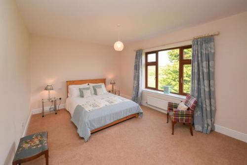 a bedroom with a bed and a window at Shawsmill, outside Hurlford in Hurlford