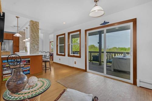 a living room with a kitchen and a dining room at Beach front oasis - Hot tub - Sleeps 7 in Keansburg