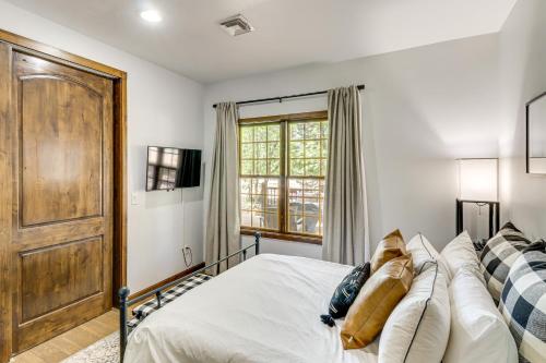 a bedroom with a bed and a window at Porch, Fire Pit Pine View Retreat in Lakeside! in Lake of the Woods