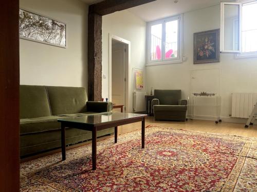 a living room with a couch and a coffee table at A lived-in apartment with soul in Santander