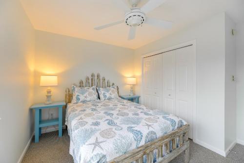 a bedroom with a bed with two tables and a ceiling fan at 2 Mi to Bethany Beach Home with Furnished Deck in Ocean View