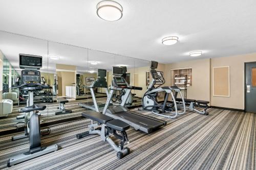 a gym with treadmills and ellipticals in a building at Candlewood Suites Hazleton by IHG in Hazleton