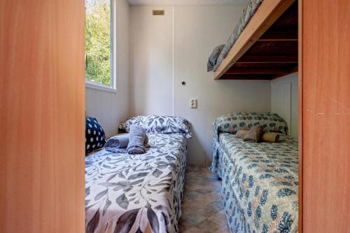 a small room with two beds and a bunk bed at Oasis on the River in Pisa