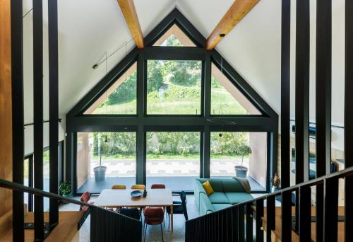 an attic living room with a large glass window at Villa Natura in Plešivica