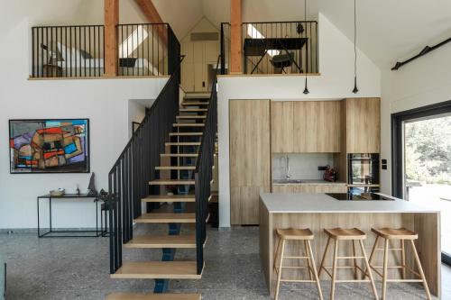 a kitchen with a staircase leading up to a loft at Villa Natura in Plešivica