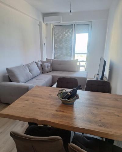 a living room with a table and a couch at Pockovi Apartments in Star Dojran