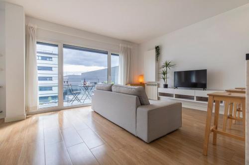 a living room with a couch and a television at Lisbon East Residence in Lisbon