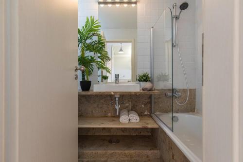 a bathroom with a sink and a tub and a mirror at Lisbon East Residence in Lisbon
