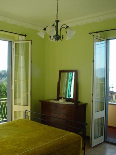 a bedroom with a bed and a television on a dresser at Locanda Miranda in Tellaro