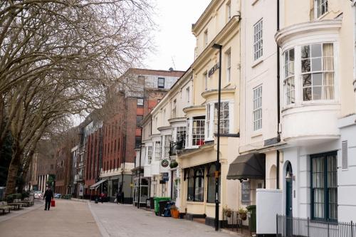 a street with buildings and a person walking down the street at Luxury 2-bed stay, Rooftop Terrace, Hot tub, By Cruise Terminal, Oxford Street in Southampton