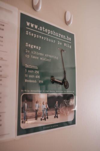 a poster of a scooter hanging on a wall at vakantiewoning aan het water in Merksplas