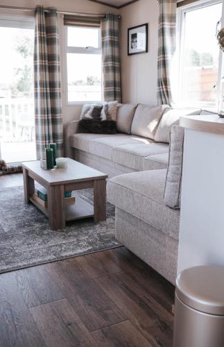 a living room with a couch and a table at vakantiewoning aan het water in Merksplas