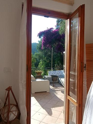 a door to a patio with a view of a couch at Casa Artigena in Rapallo