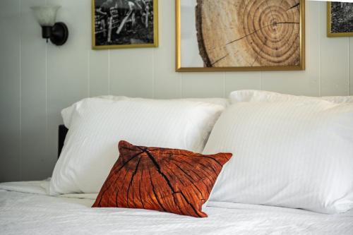 a pillow sitting on top of a bed with pillows at Lumber Jill Lodge 17 King Bed Retreat in Balsam Lake