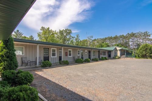 an exterior view of a building at Lumber Jill Lodge 16 Two Queen Room in Balsam Lake
