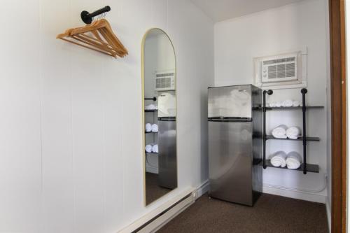 a kitchen with a mirror and a refrigerator at Lumberjill Lodge 11 King Room in Balsam Lake